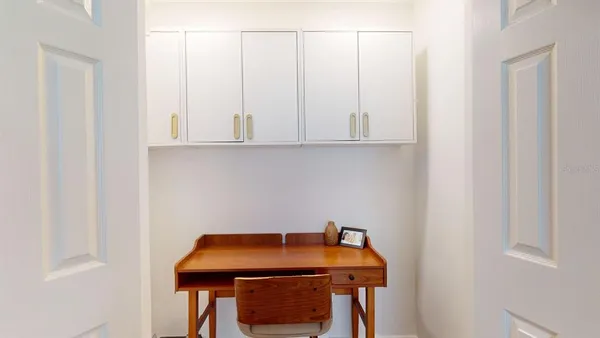 a view of a kitchen area with furniture and wooden floor
