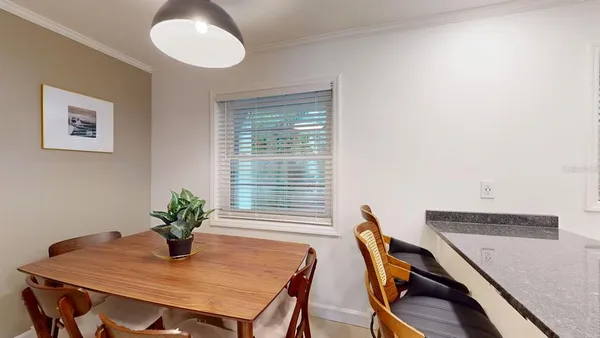 a kitchen with sink a granite counter top a stove and cabinets