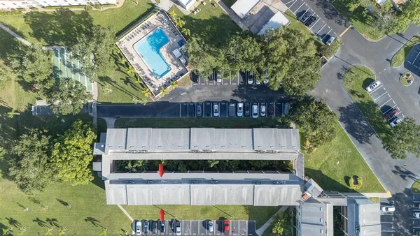 a front view of a building with a garden and plants