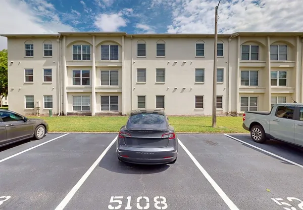 a view of a chairs and table in front of a house