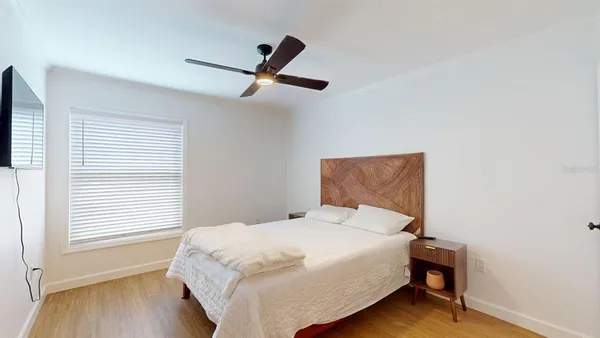 a bedroom with a bed and a window