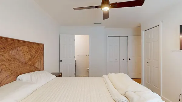 a bedroom with a bed and a couch