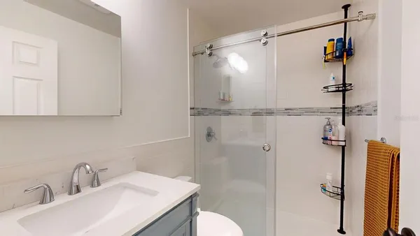 a bathroom with a sink toilet and shower