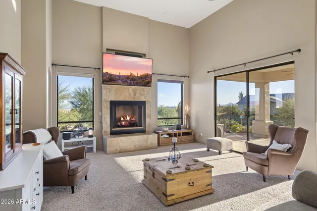 a large bedroom with a large bed and a chandelier