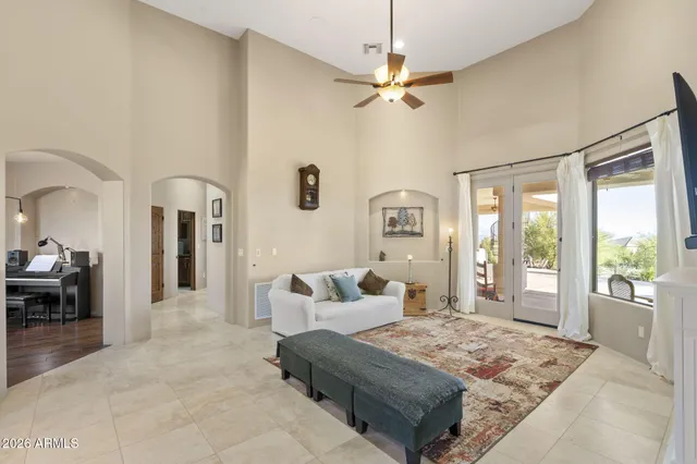 a living room with furniture and a view of kitchen