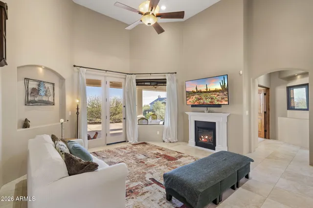 a living room with furniture large window and a fireplace