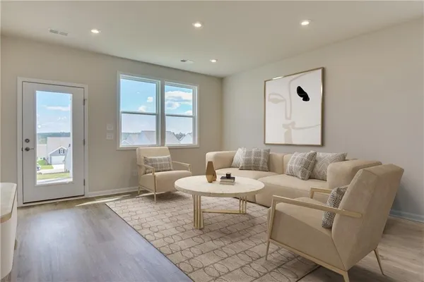 a living room with furniture and wooden floor