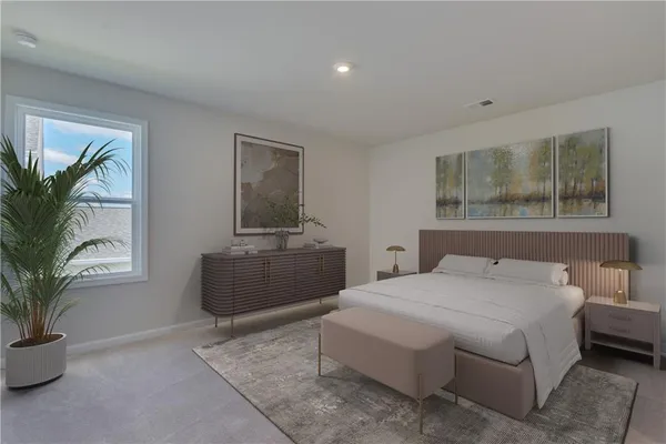 a bedroom with a large bed and a potted plant