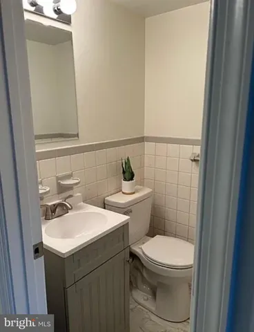 a bathroom with a sink mirror and toilet