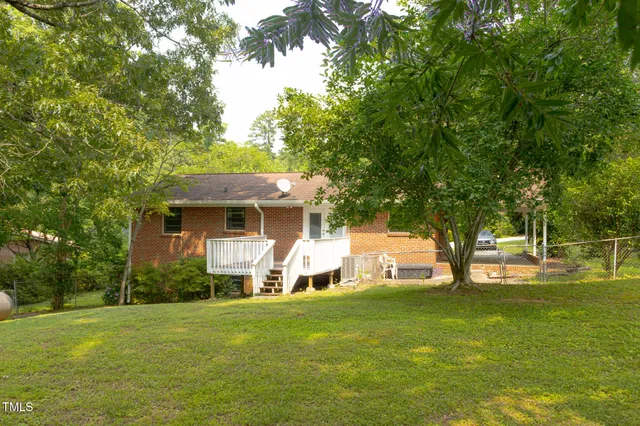 a view of a backyard with large trees