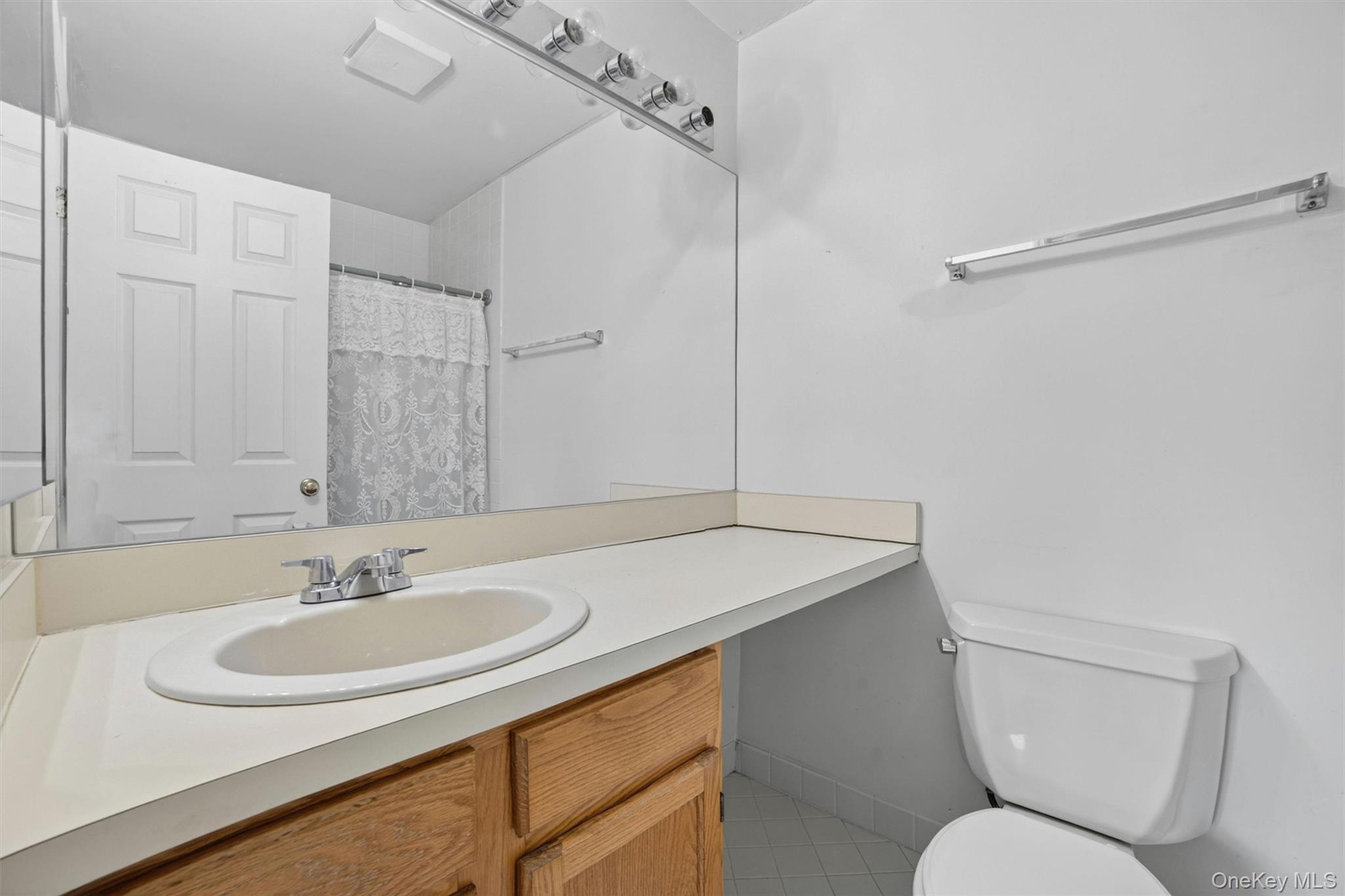 116 Fields Lane Peekskill, NY 10566 - Photo 24 of 40 a bathroom with a sink toilet and a mirror