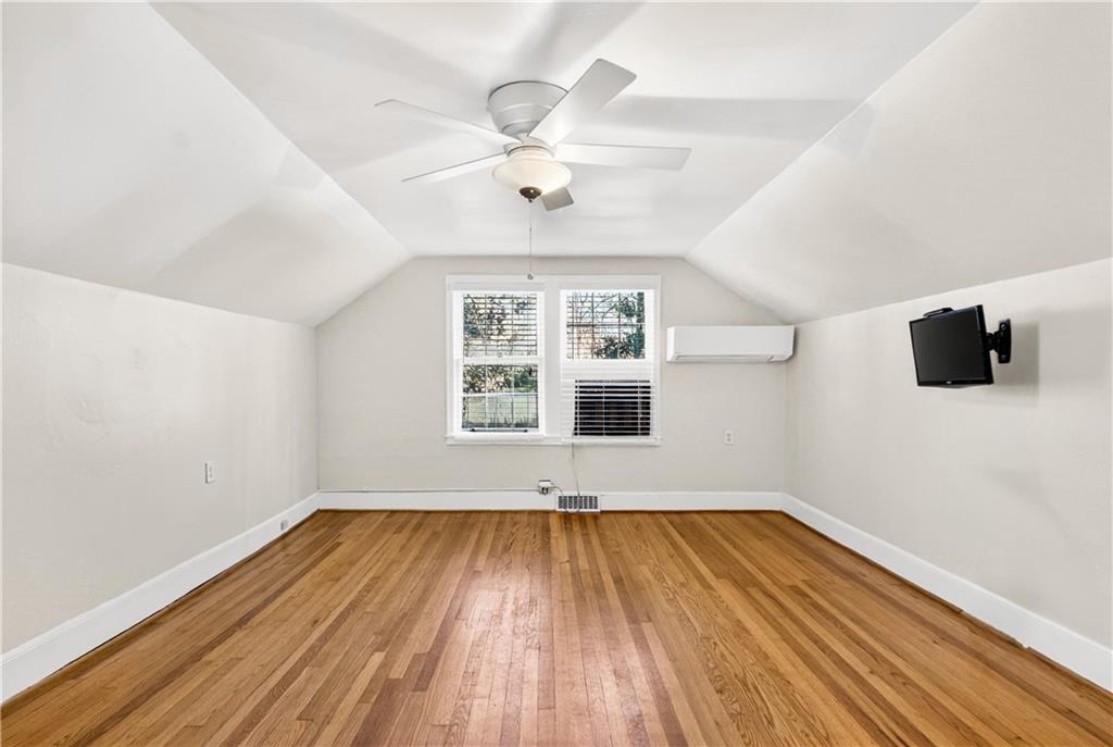 613 Pelham Road Northeast Atlanta, GA 30324 - Photo 11 of 24 an empty room with wooden floor and windows