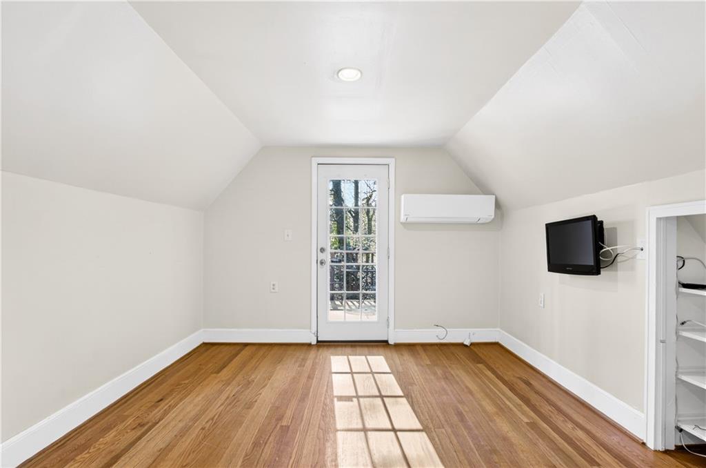 613 Pelham Road Northeast Atlanta, GA 30324 - Photo 13 of 24 an empty room with wooden floor and windows