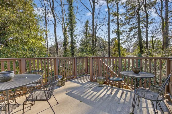 a view of a balcony with two chairs and a table