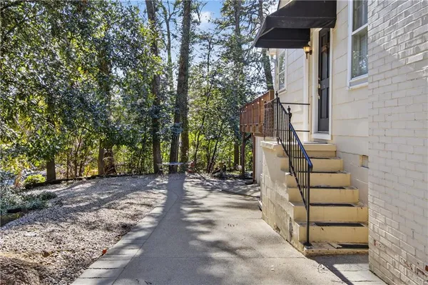 a view of a pathway of a house with wooden stairs