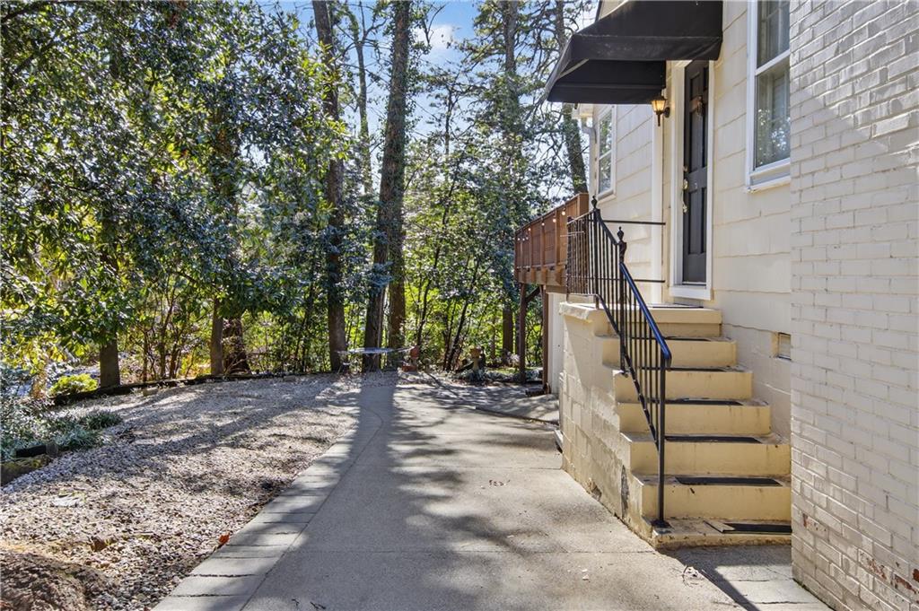 613 Pelham Road Northeast Atlanta, GA 30324 - Photo 22 of 24 a view of a pathway of a house with wooden stairs