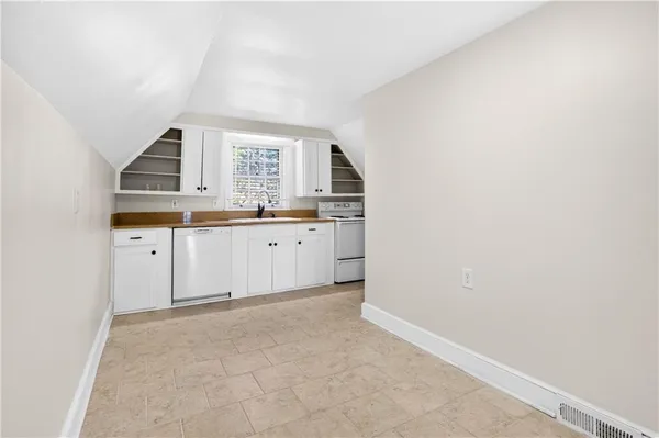 a kitchen with granite countertop a sink and cabinets