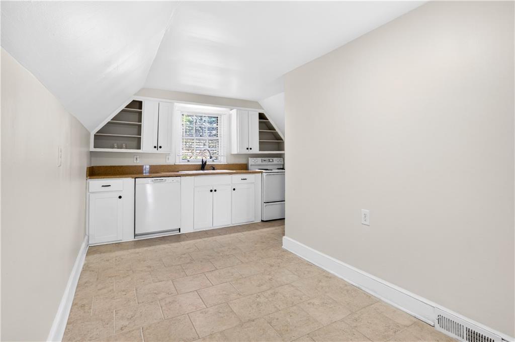 613 Pelham Road Northeast Atlanta, GA 30324 - Photo 3 of 24 a kitchen with granite countertop a sink and cabinets