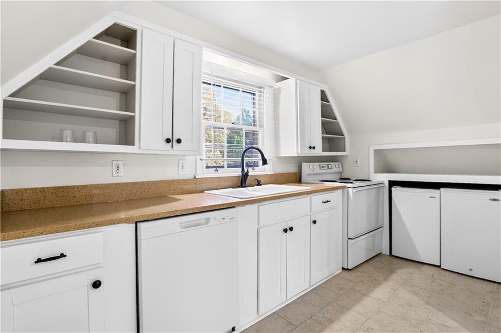 613 Pelham Road Northeast Atlanta, GA 30324 - Photo 4 of 24 a kitchen with granite countertop white cabinets and white appliances
