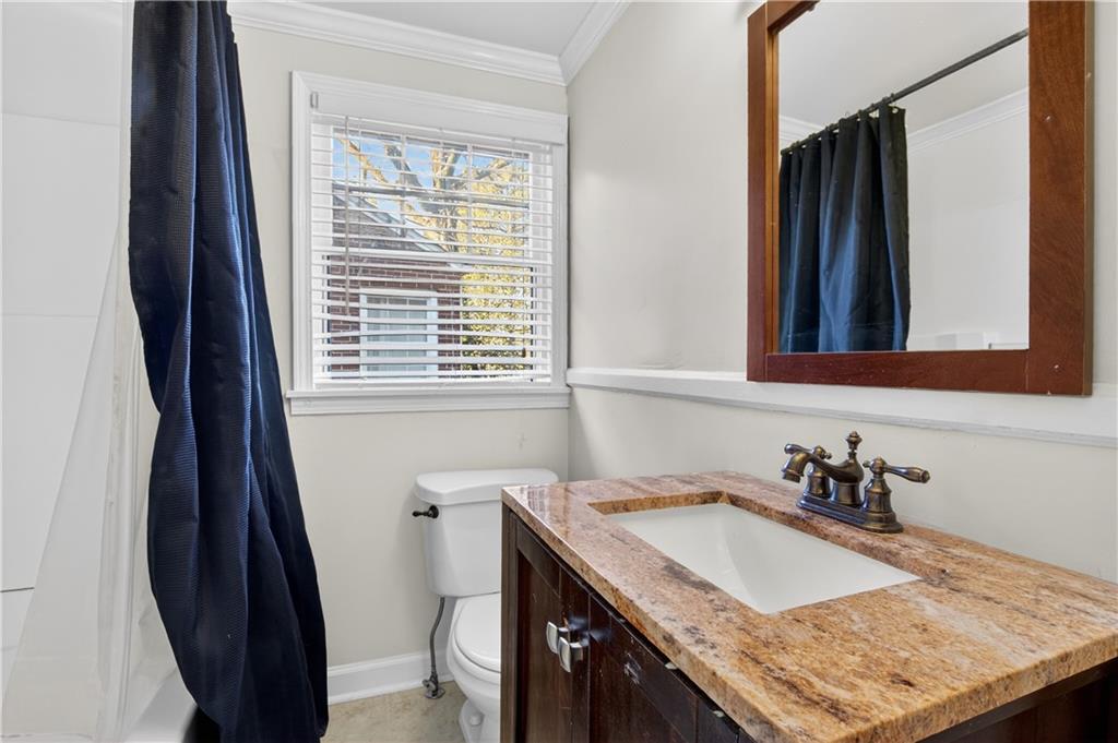 613 Pelham Road Northeast Atlanta, GA 30324 - Photo 6 of 24 a bathroom with a granite countertop sink and a window