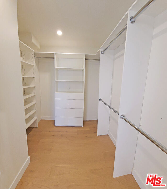 468 South Roxbury Drive, Unit PH Beverly Hills, CA 90212 - Photo 12 of 18 a view of walk in closet with empty racks