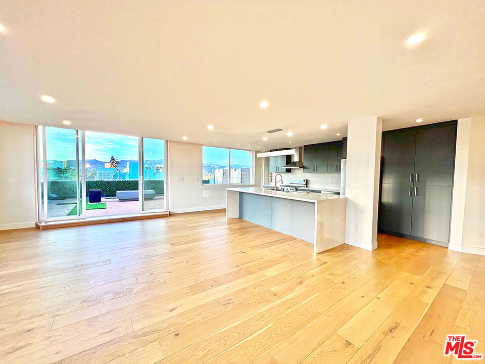 468 South Roxbury Drive, Unit PH Beverly Hills, CA 90212 - Photo 3 of 18 a view of kitchen with kitchen island a sink cabinets and wooden floor