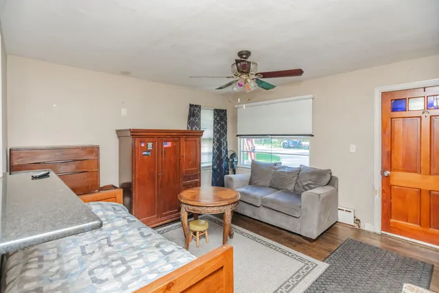 a living room with furniture a ceiling fan and a rug