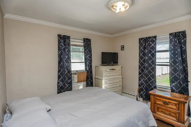 a bedroom with a bed and a television