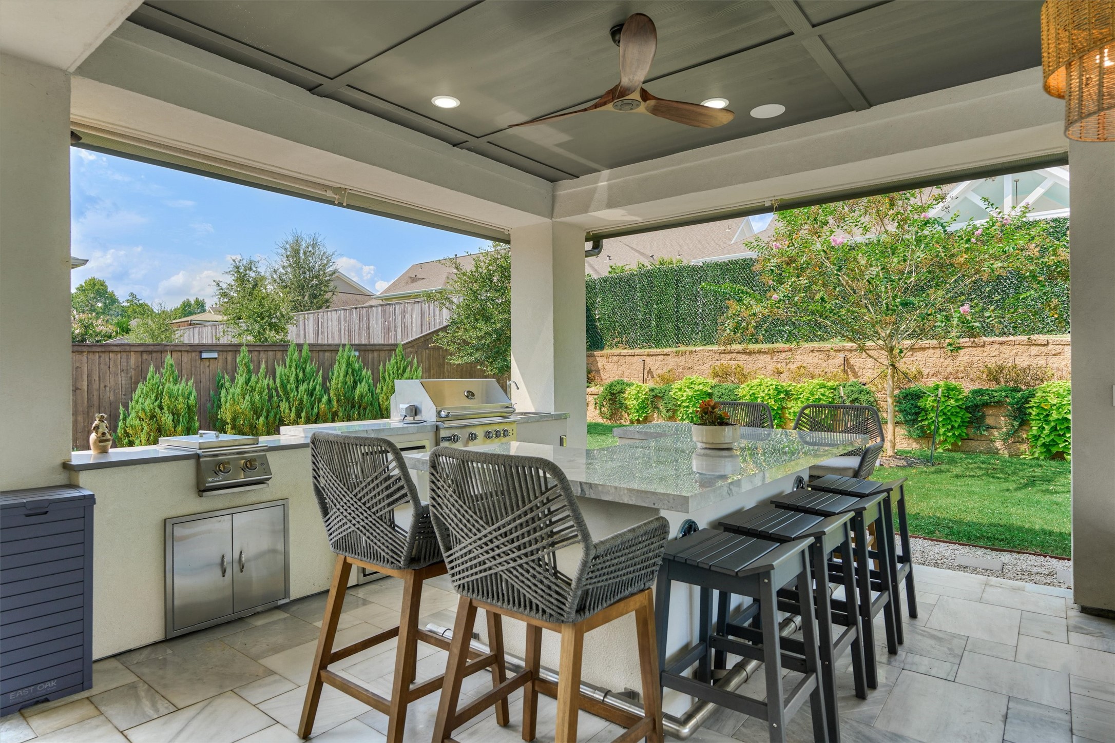 2017 Bennet Lane Conroe, TX 77384 - Photo 40 of 48 Outdoor kitchen with professional grill, side burner, beverage fridge & wine cooler, and a oversized countertop dining area for effortless entertaining