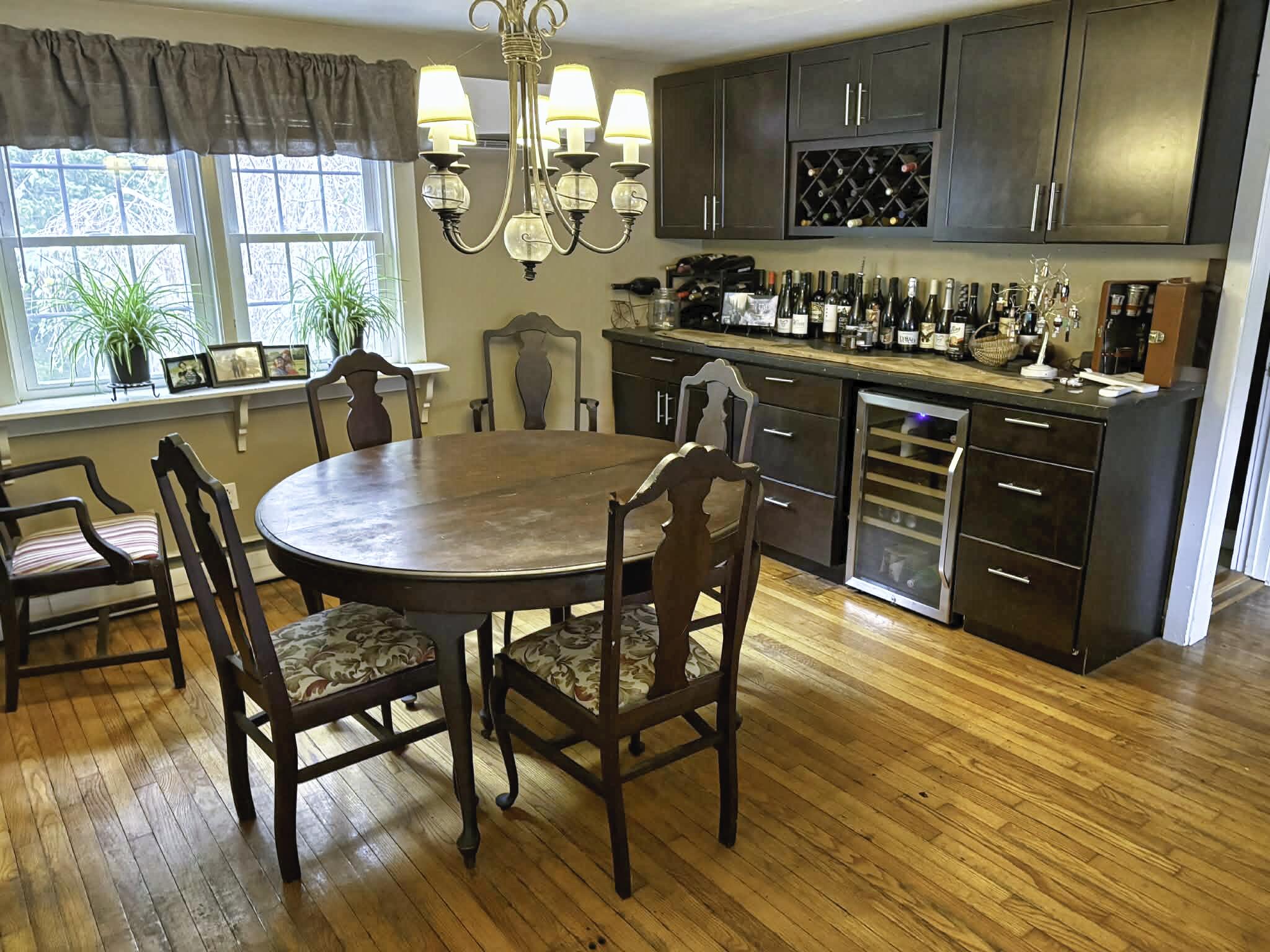 13 Allen Street Harwich, MA 02645 - Photo 12 of 31 a kitchen with stainless steel appliances a dining table chairs and wooden floor