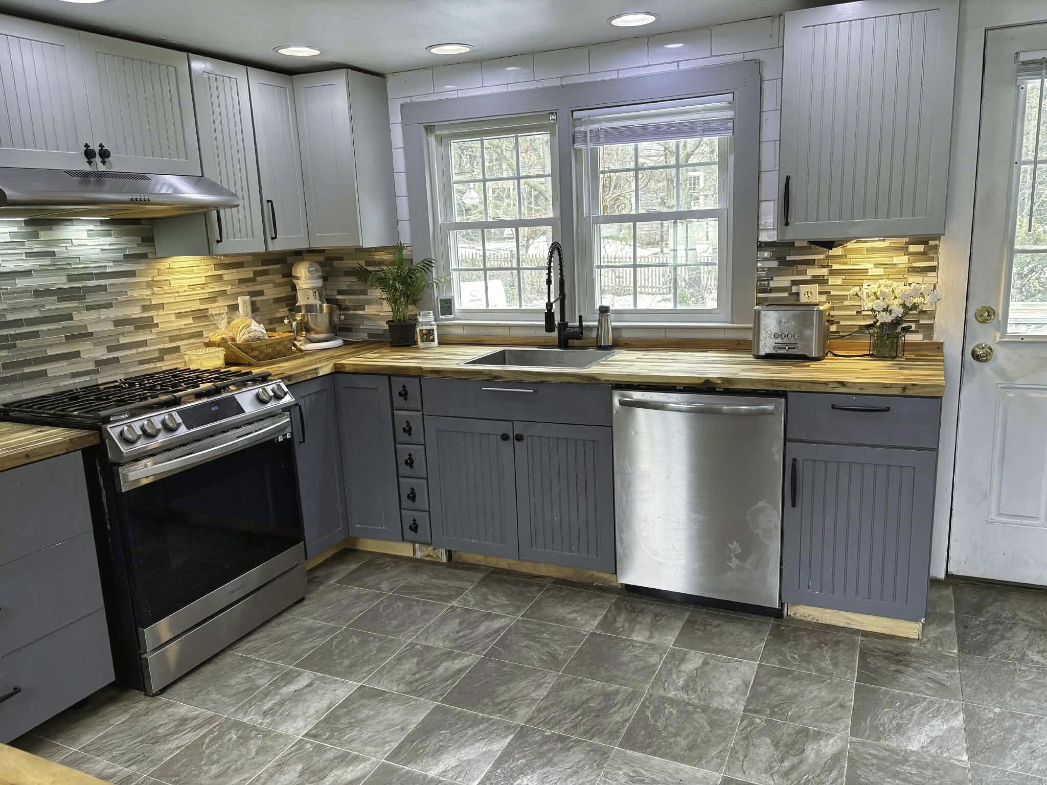 13 Allen Street Harwich, MA 02645 - Photo 4 of 31 a kitchen with stainless steel appliances granite countertop a stove a sink and a microwave