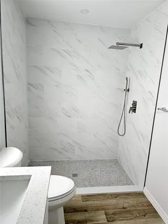 a bathroom with a toilet and a shower