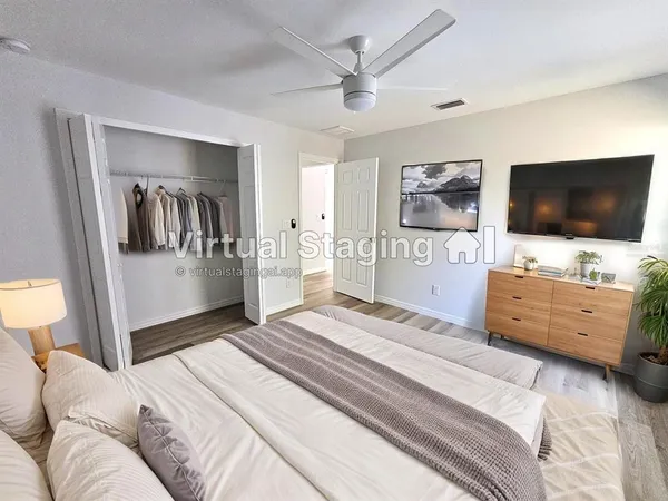 a bedroom with furniture and flat screen tv