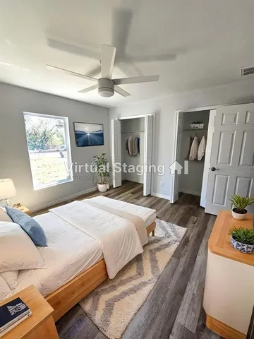 a bedroom with a bed wooden floor and window