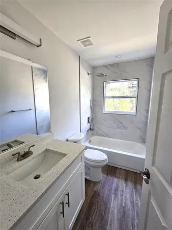a bathroom with a sink a toilet and a bathtub