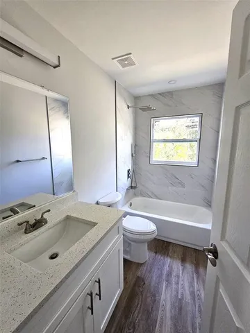 a bathroom with a sink a toilet and a bathtub