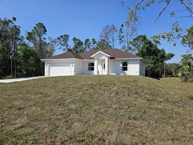 a front view of a house with a garden