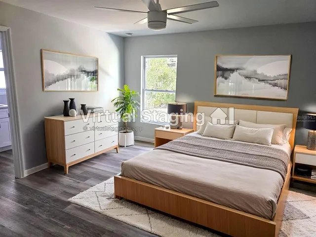 a spacious bedroom with a bed and a chandelier