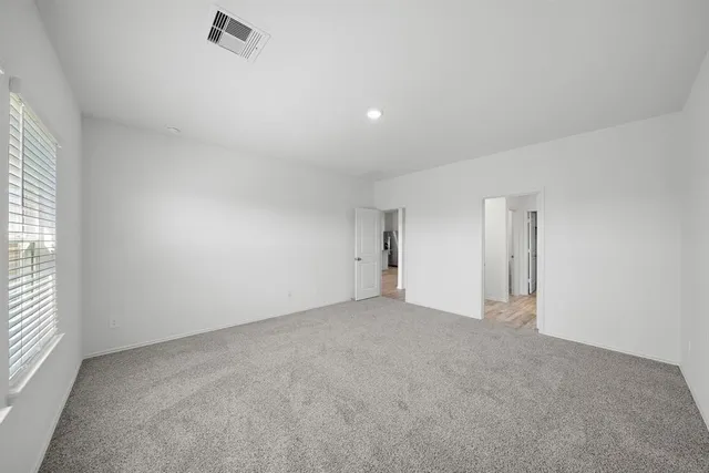 an empty room with a empty space and windows