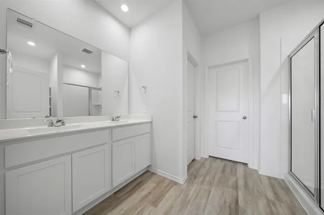 a bathroom with a double vanity sink and mirror