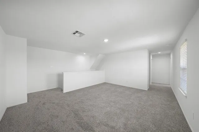 an empty room with a empty space and windows