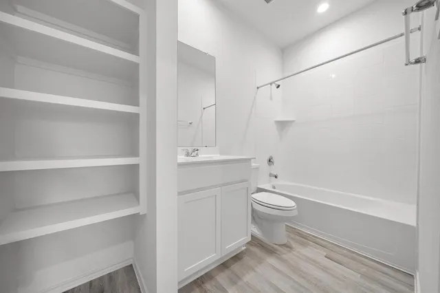 a bathroom with a white toilet and a shower