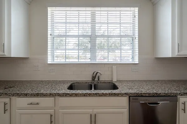 a spacious bathroom with a toilet sink and mirror