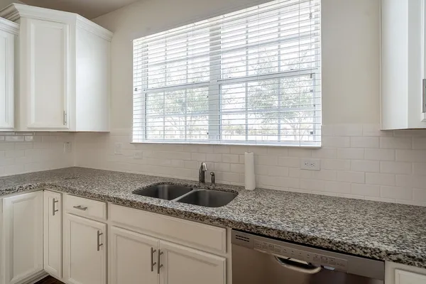 a white bath tub sitting next to a white sink