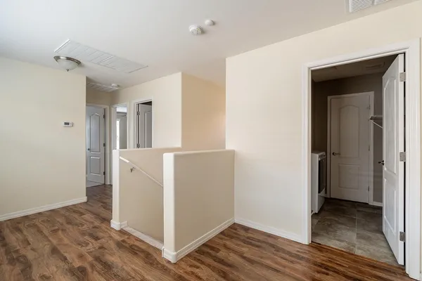 an empty room with a window and a fan