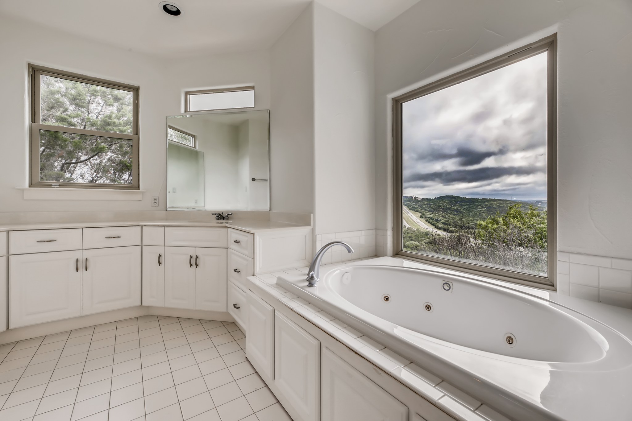 2800 Waymaker Way, Unit 27 Austin, TX 78746 - Photo 12 of 17 Bathroom with vanity, a whirlpool tub, and light tile patterned flooring