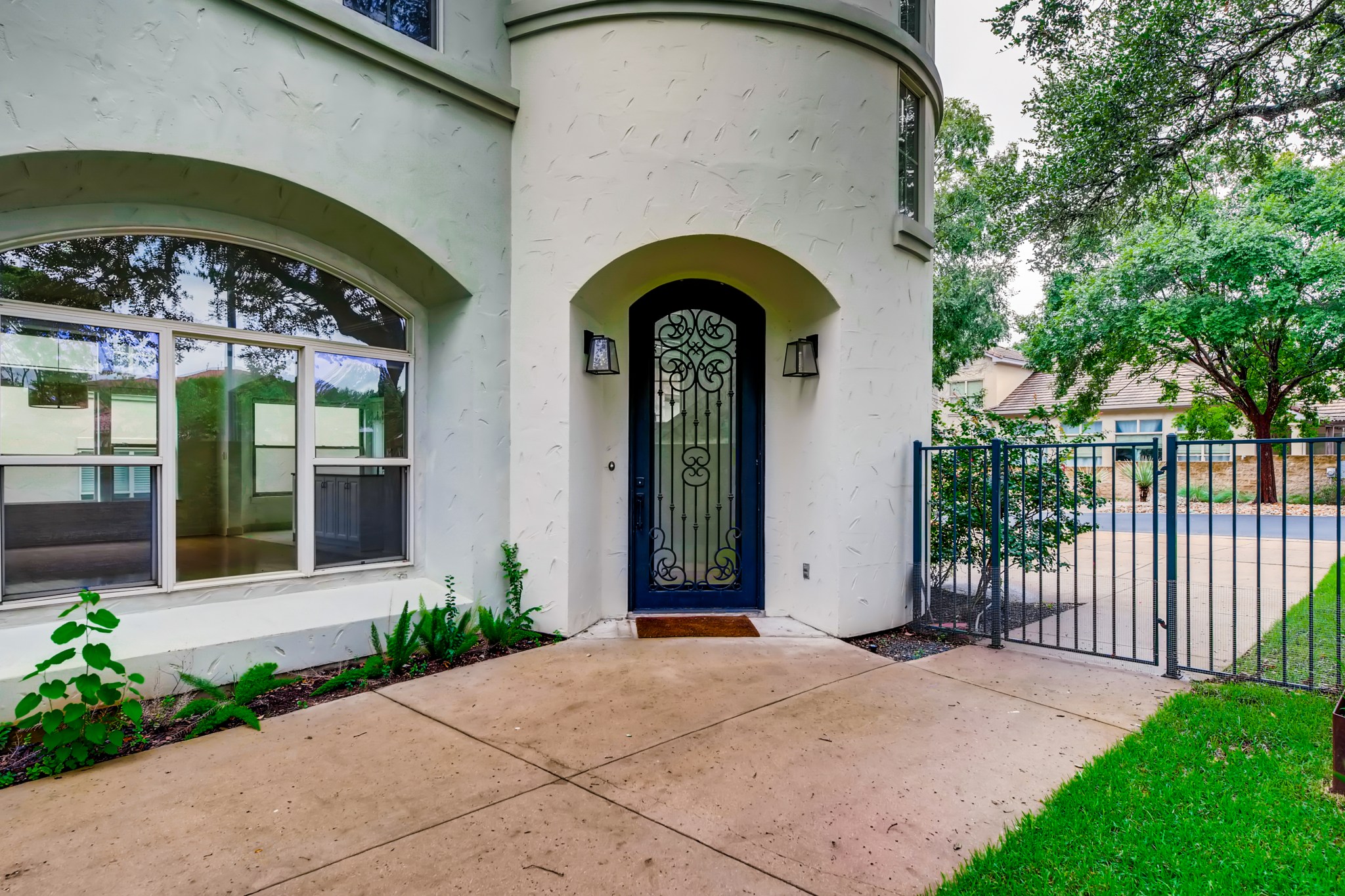 2800 Waymaker Way, Unit 27 Austin, TX 78746 - Photo 2 of 17 View of exterior entry with a gate and stucco siding