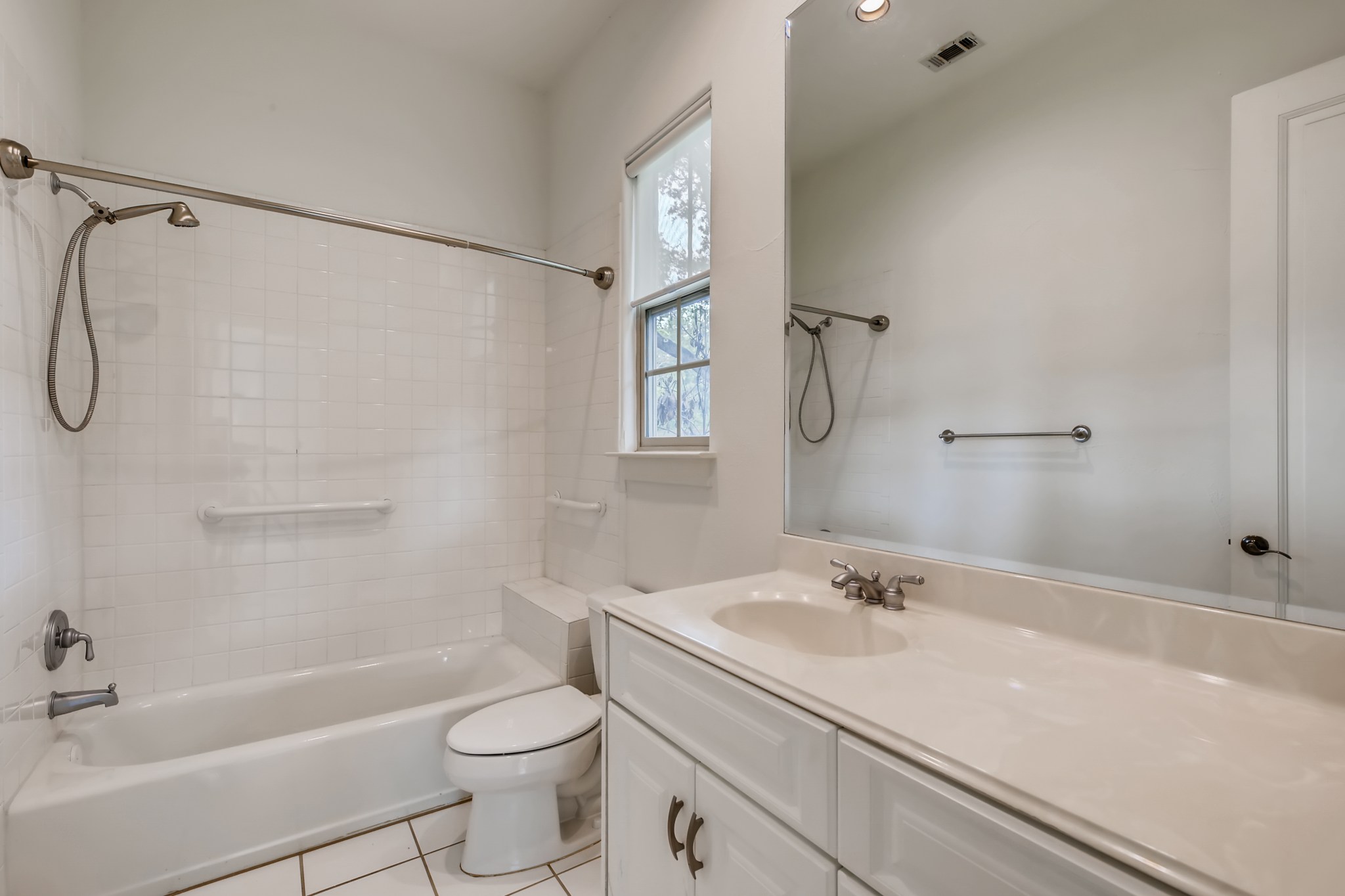 2800 Waymaker Way, Unit 27 Austin, TX 78746 - Photo 9 of 17 Bathroom with vanity, light tile patterned flooring, and shower / bath combination