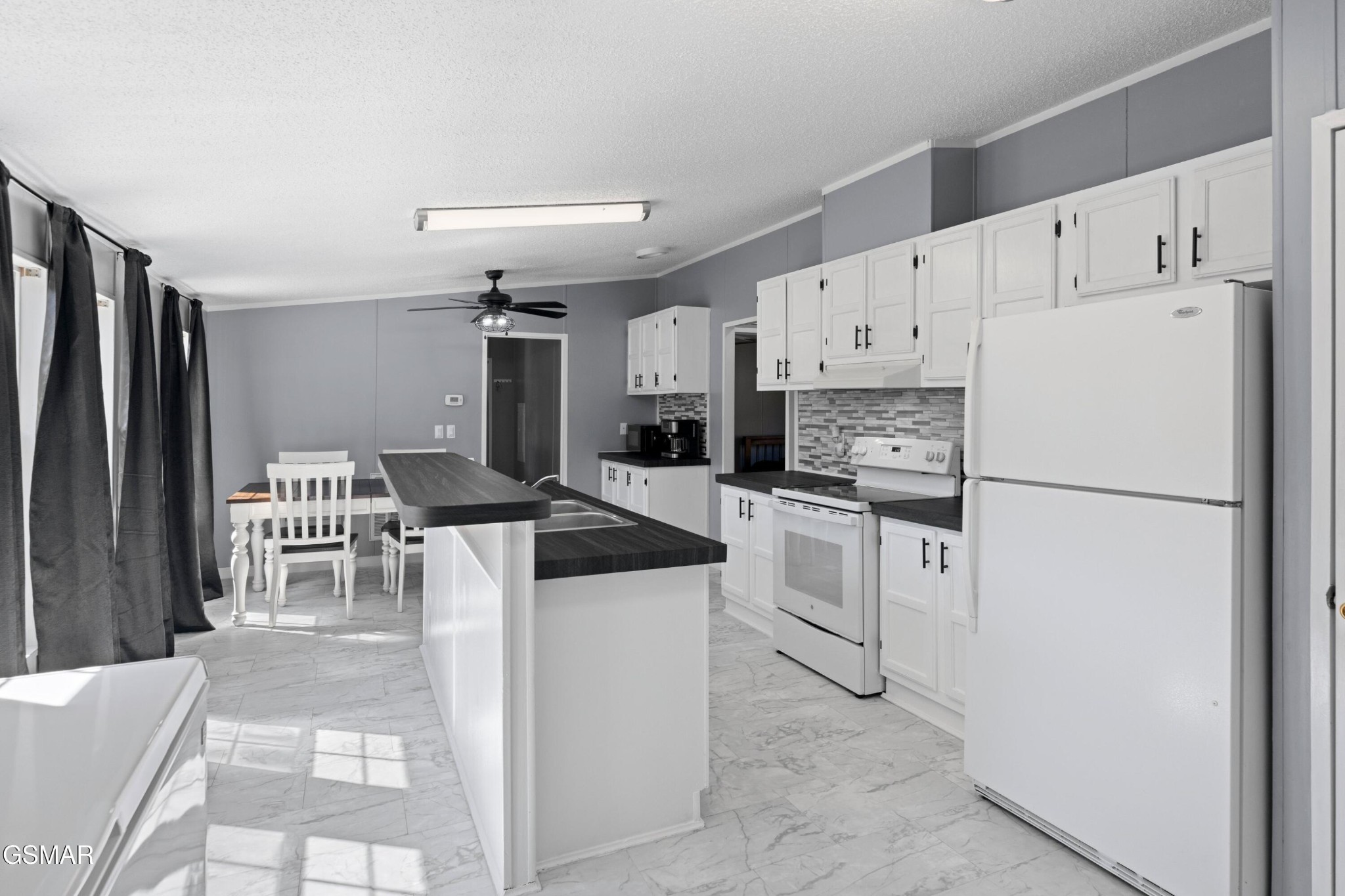 1570 Little Valley Road Maynardville, TN 37807 - Photo 7 of 31 a kitchen with white cabinets and white appliances