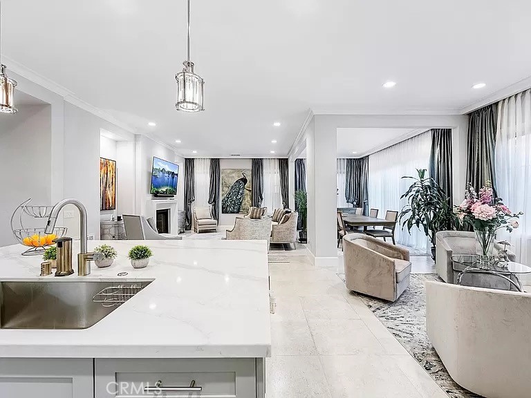 65 Rockinghorse Irvine, CA 92602 - Photo 11 of 45 a large white kitchen with lots of counter top space and living room view